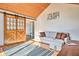 Comfortable living room featuring hardwood floors, wood-paneled ceiling, and sliding barn doors at 4030 W 193Rd St, Westfield, IN 46074