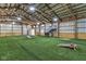 Spacious indoor recreation area with artificial turf, basketball, games, and ample lighting at 4030 W 193Rd St, Westfield, IN 46074