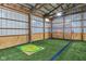 Indoor recreation space with artificial turf, golf games, and a safe baseball net at 4030 W 193Rd St, Westfield, IN 46074