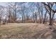 Spacious backyard with mature trees and a storage shed offering ample space at 5053 Manker St, Indianapolis, IN 46227