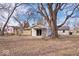 Large backyard featuring mature trees and a patio space, perfect for outdoor activities at 5053 Manker St, Indianapolis, IN 46227