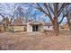 Backyard patio with sliding glass door to the home and mature shade trees at 5053 Manker St, Indianapolis, IN 46227