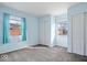 Bright bedroom with two closets, ample natural light, and blue painted walls at 5053 Manker St, Indianapolis, IN 46227