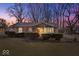 Cozy home with mature trees, landscaping and covered parking at the end of the driveway at 5053 Manker St, Indianapolis, IN 46227
