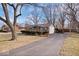 Charming ranch home with a large front yard, mature trees, and an asphalt driveway at 5053 Manker St, Indianapolis, IN 46227