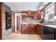 Kitchen featuring tiled accent wall and floor, laminate counters and ample wooden cabinets at 5053 Manker St, Indianapolis, IN 46227