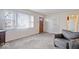 Inviting living room with neutral carpet, fresh paint, and large windows providing ample natural light at 5053 Manker St, Indianapolis, IN 46227