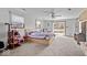 Spacious main bedroom with a ceiling fan, sliding glass door, and neutral-colored carpet at 5053 Manker St, Indianapolis, IN 46227