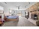 Large main bedroom with a stone fireplace, a ceiling fan, and neutral-colored carpet at 5053 Manker St, Indianapolis, IN 46227