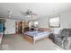 Carpeted main bedroom boasts natural light, a ceiling fan, and a sitting area at 5053 Manker St, Indianapolis, IN 46227