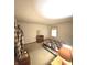 Bedroom with carpeted floor, a window and a wooden dresser at 5430 Milhouse Rd, Indianapolis, IN 46221