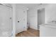 A bright bathroom features a glass-enclosed shower, double vanity with white cabinets, and wood-look flooring at 567 Hidden Hills Dr, Pittsboro, IN 46167