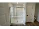 Bathroom with glass-enclosed walk-in shower, white subway tile, and a built-in bench at 567 Hidden Hills Dr, Pittsboro, IN 46167