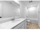 Bright bathroom featuring a white vanity with a large mirror, shower-tub combo and neutral wood-look floors at 567 Hidden Hills Dr, Pittsboro, IN 46167