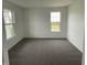 Bright bedroom featuring plush carpet, neutral walls, and double hung windows at 567 Hidden Hills Dr, Pittsboro, IN 46167