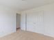 Bright bedroom featuring plush carpeting and a large closet with classic double doors at 567 Hidden Hills Dr, Pittsboro, IN 46167