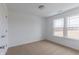 This bedroom offers neutral carpet, bright windows, and white walls at 567 Hidden Hills Dr, Pittsboro, IN 46167
