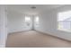 An open, airy bedroom with carpeted floor and natural light from two windows at 567 Hidden Hills Dr, Pittsboro, IN 46167