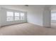 Bright bedroom featuring natural light, neutral carpet, and entrance to bathroom at 567 Hidden Hills Dr, Pittsboro, IN 46167