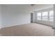 Spacious bedroom with natural light features neutral carpet, white walls, and entrance to bathroom at 567 Hidden Hills Dr, Pittsboro, IN 46167