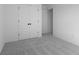 The bedroom features plush gray carpet, white walls and trim, and paneled doors to the closet at 567 Hidden Hills Dr, Pittsboro, IN 46167