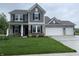 Charming two-story home with gray siding, brick accents, and a well-manicured lawn at 567 Hidden Hills Dr, Pittsboro, IN 46167