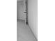 Hallway featuring gray carpet, white walls, and an open door at 567 Hidden Hills Dr, Pittsboro, IN 46167