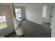 Hallway featuring plush carpet, neutral walls, and an open doorway at 567 Hidden Hills Dr, Pittsboro, IN 46167