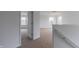 Light filled hallway featuring neutral carpet and multiple rooms at 567 Hidden Hills Dr, Pittsboro, IN 46167