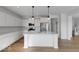 A modern kitchen featuring white cabinets, stainless steel appliances, and an island with pendant lighting at 567 Hidden Hills Dr, Pittsboro, IN 46167