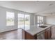 Bright kitchen island boasts stainless sink, modern countertop, and view to yard at 567 Hidden Hills Dr, Pittsboro, IN 46167