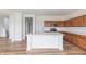 Modern kitchen with island, stainless steel appliances, and wood floors at 567 Hidden Hills Dr, Pittsboro, IN 46167
