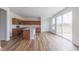 Bright kitchen features stainless appliances, wooden cabinets, an island and wood flooring at 567 Hidden Hills Dr, Pittsboro, IN 46167