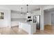 A modern kitchen featuring white cabinets, stainless steel appliances, and an island with pendant lighting at 567 Hidden Hills Dr, Pittsboro, IN 46167
