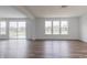 Spacious living room with hardwood floors, bright windows, and a patio door at 567 Hidden Hills Dr, Pittsboro, IN 46167