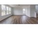 Large open-concept living room featuring hardwood floors and modern windows at 567 Hidden Hills Dr, Pittsboro, IN 46167