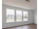Bright living room showcasing natural light from three large windows at 567 Hidden Hills Dr, Pittsboro, IN 46167