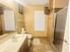 Cozy bathroom featuring a vanity with sink, toilet, and shower stall with decorative tile at 6405 Oyster Key Ln, Plainfield, IN 46168