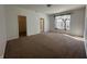 Bedroom with neutral carpet, large window, and closet for ample storage at 6405 Oyster Key Ln, Plainfield, IN 46168