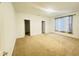 Neutral bedroom with a carpeted floor, one window, and two doors: one closet, one to the hallway at 6405 Oyster Key Ln, Plainfield, IN 46168