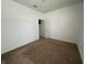 Bedroom featuring neutral carpet, white walls and a door leading to the closet at 6405 Oyster Key Ln, Plainfield, IN 46168