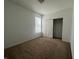 Bedroom featuring neutral carpet, window with blinds, and closet space at 6405 Oyster Key Ln, Plainfield, IN 46168