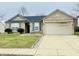 Charming brick home with blue shutters, well-manicured lawn, and a two-car garage at 6405 Oyster Key Ln, Plainfield, IN 46168