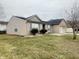 Side view of brick and vinyl home, showcasing the home's architectural style and landscaping at 6405 Oyster Key Ln, Plainfield, IN 46168