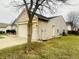View of the home's side, showcasing the brick, vinyl siding, and two-car garage at 6405 Oyster Key Ln, Plainfield, IN 46168