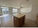 Kitchen with a center island and view into the main living space at 6405 Oyster Key Ln, Plainfield, IN 46168