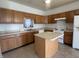 Traditional kitchen featuring wood cabinetry, an island, and modern appliances at 6405 Oyster Key Ln, Plainfield, IN 46168