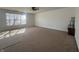 Carpeted living room offering ample sunlight from a large window at 6405 Oyster Key Ln, Plainfield, IN 46168
