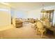 Spacious living room with neutral carpet, chandelier, and ample seating at 6405 Oyster Key Ln, Plainfield, IN 46168