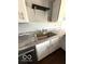Stainless steel sink with granite countertops and white cabinetry at 7659 Misty Meadow Dr, Indianapolis, IN 46217